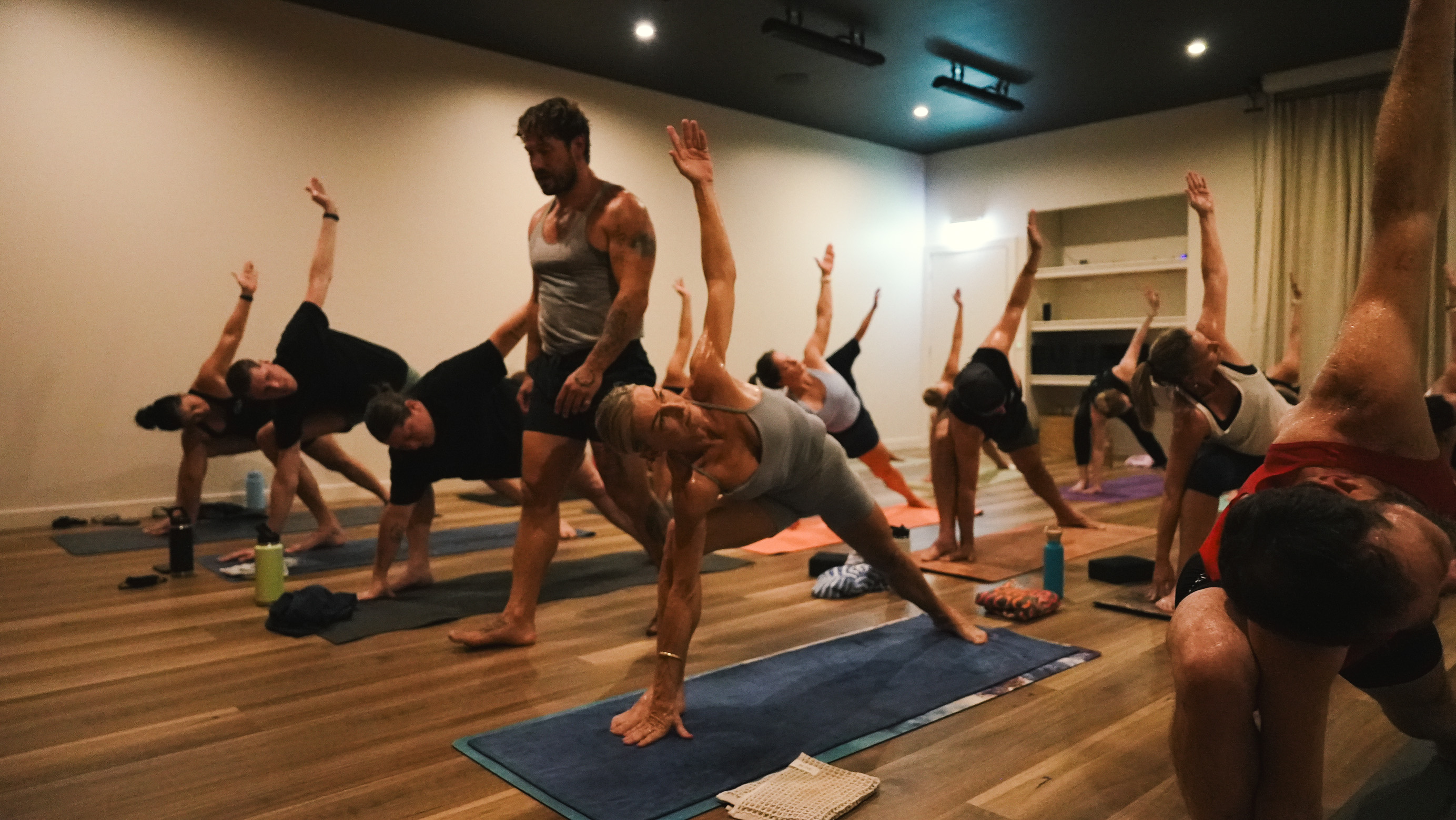 A Flow teacher guiding participants through a yoga class in the studio