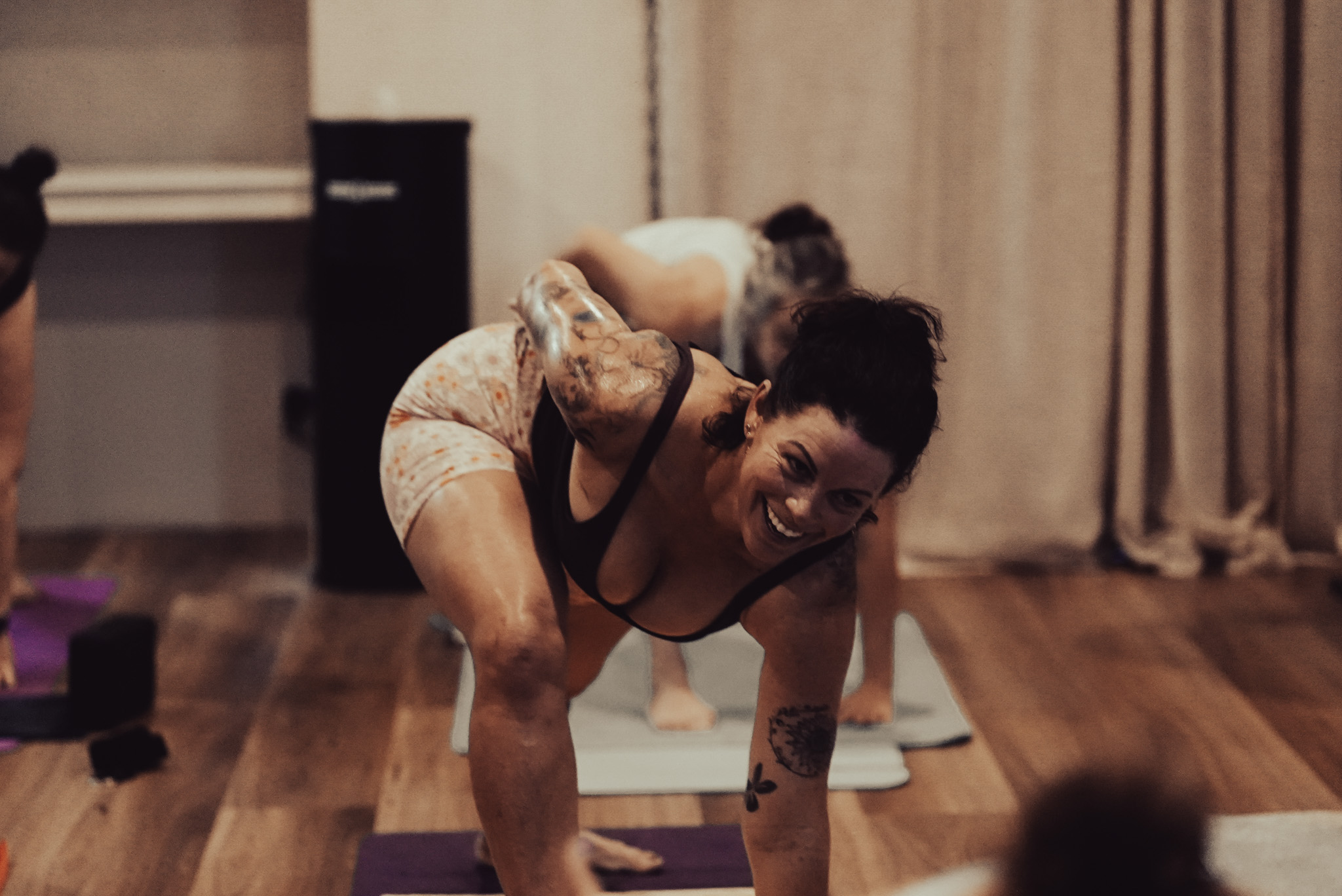 A smiling participant in a Flow yoga class