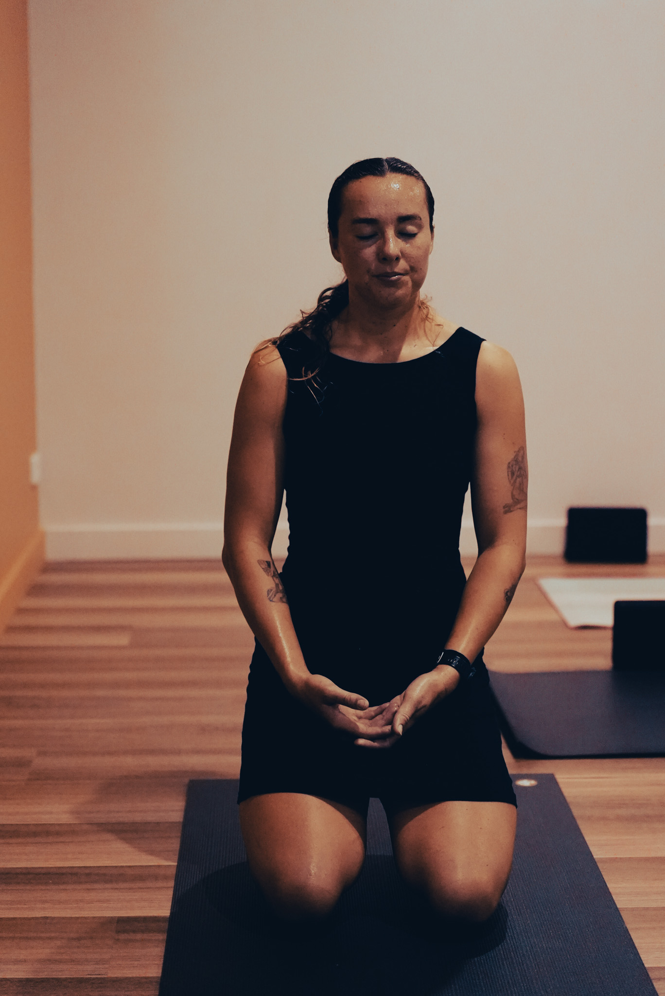 A participant seated on a yoga mat at Flow